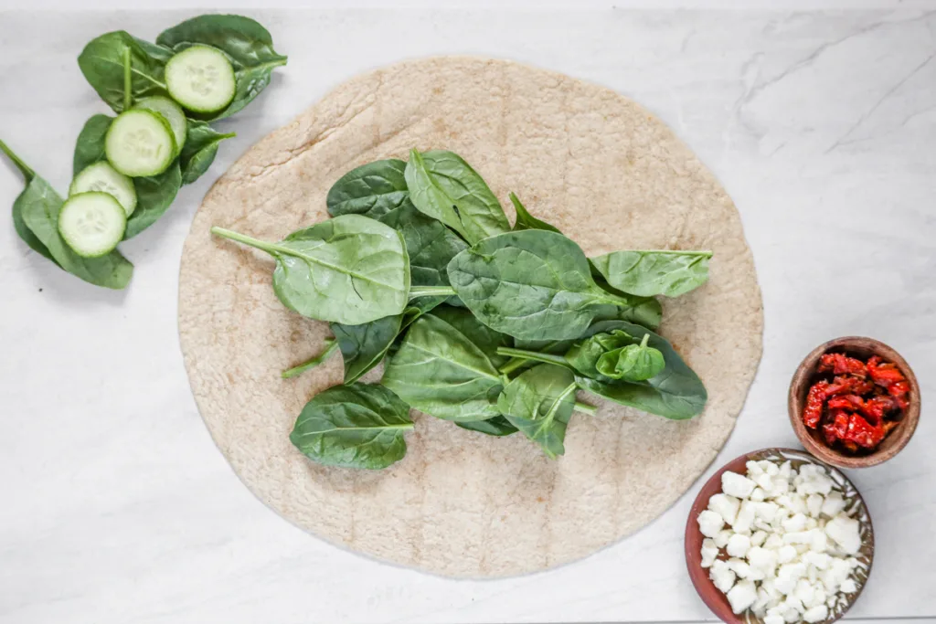 step 1 of recipe: lay spinach on wrap