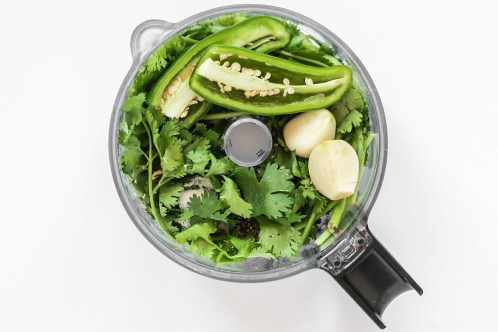 ingredients for the cilantro lime vinaigrette in a food processor